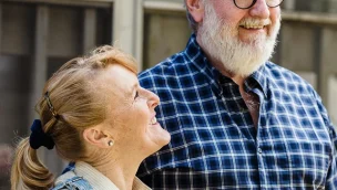 a man and woman smiling at each other people